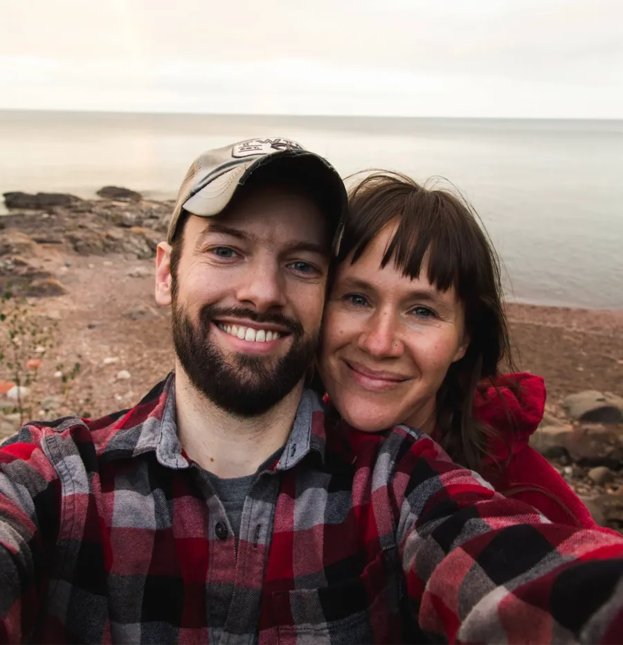 Eric and a woman taking a selfie by the water